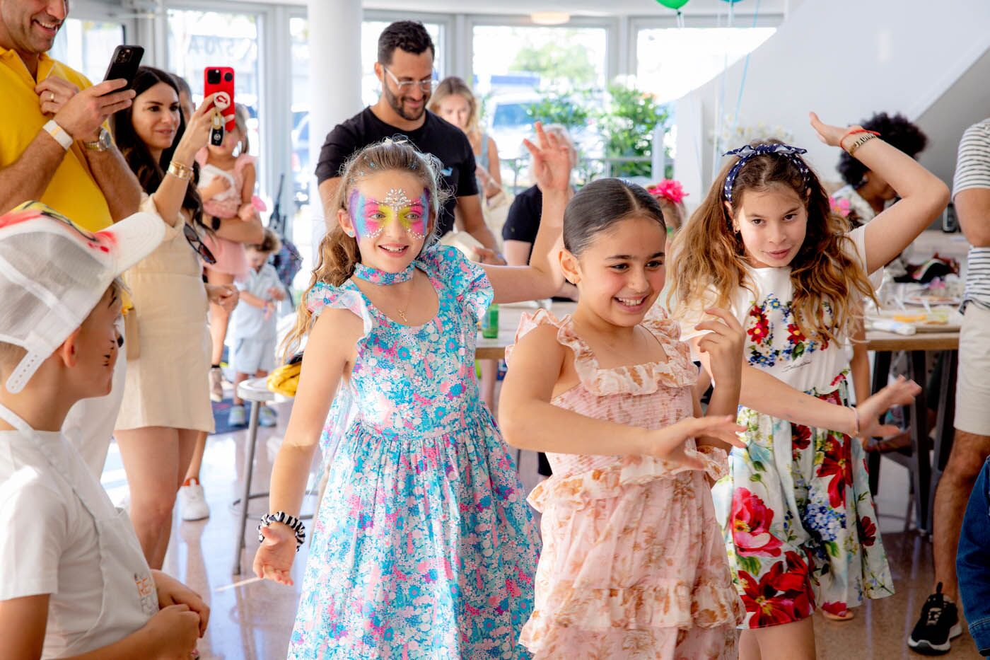 Little girls wearing butterfly masks at The Real Food Academy Miami's kids birthday pary place.