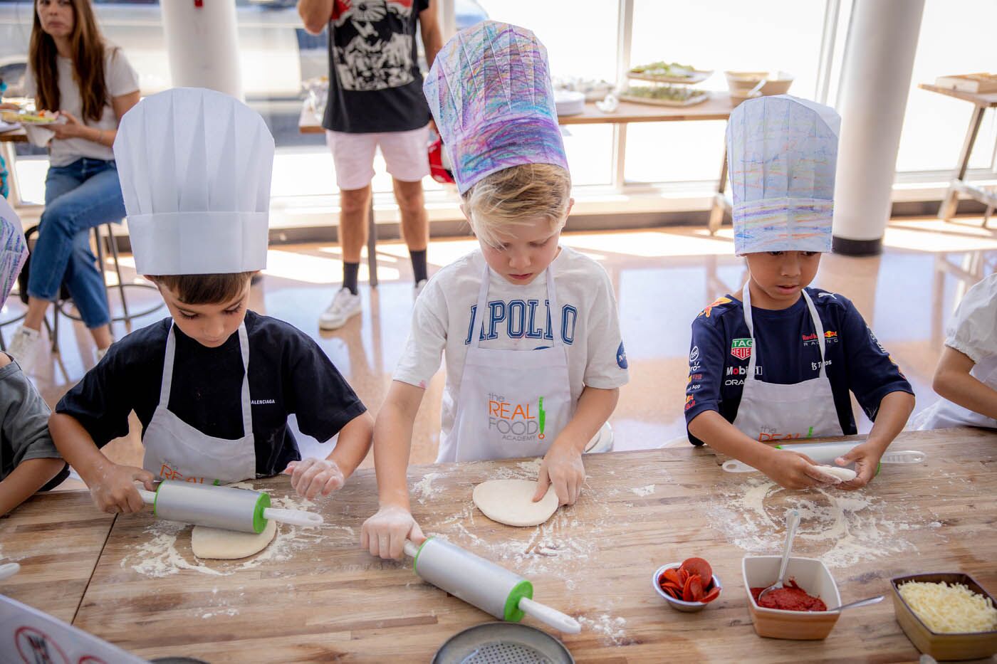 Two young kids making fresh food at Miami kids birthday party places. 