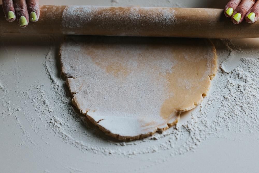 A person rolls out a pastry crust for The Real Food Academy's rustic french apple tart and crust recipe.